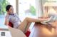 A woman sitting in a chair with her legs crossed.