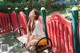 A woman sitting on a bench in a park.